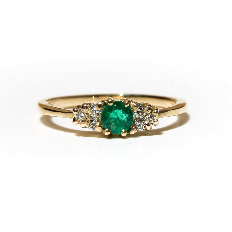 Anillo Beatriz en oro 18k con esmeralda central de laboratorio y seis diamantes laterales.